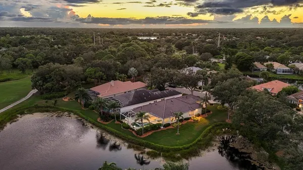an aerial view of residential houses with outdoor space and river