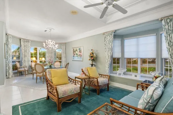 a dining room with furniture a chandelier and wooden floor