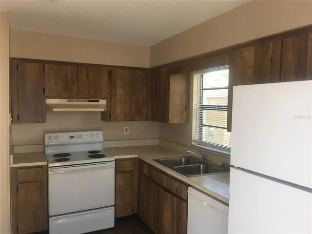 a kitchen with a stove microwave and sink