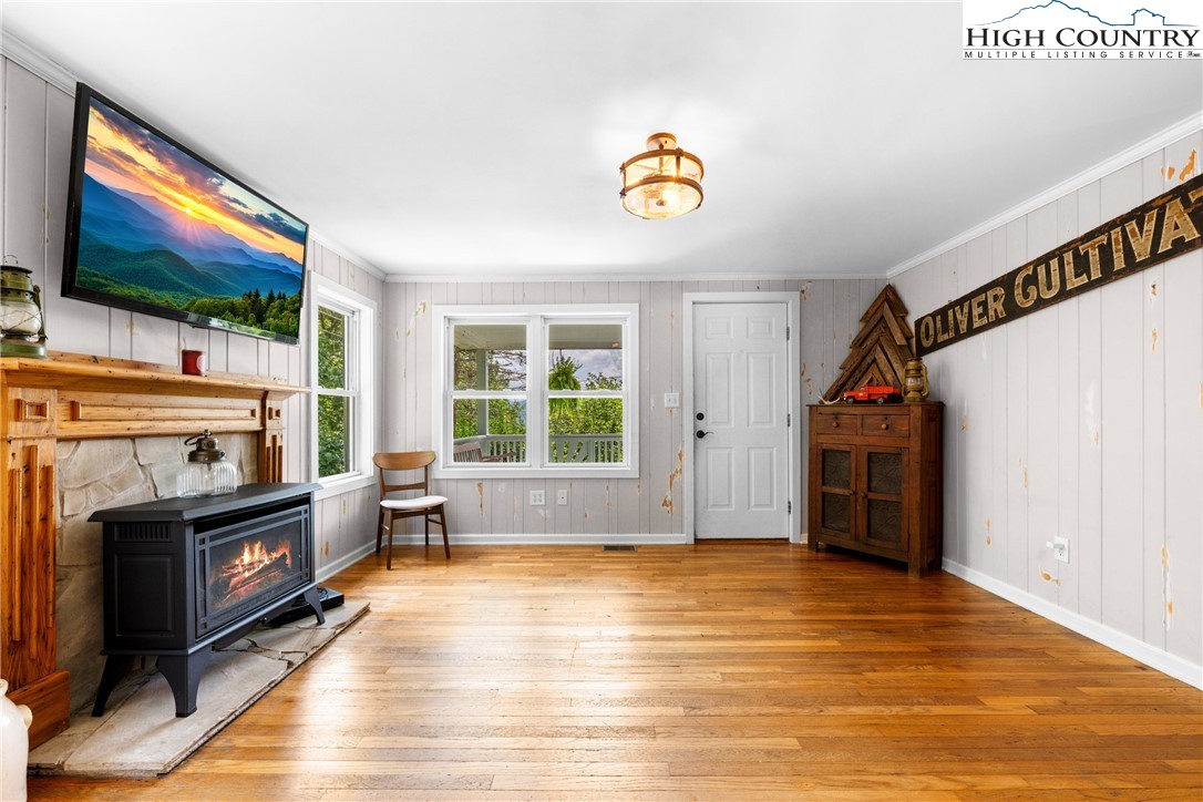 261 Tumbling Brook Road Banner Elk, NC 28604 - Photo 11 of 39 a view of empty room with a fireplace and wooden floor