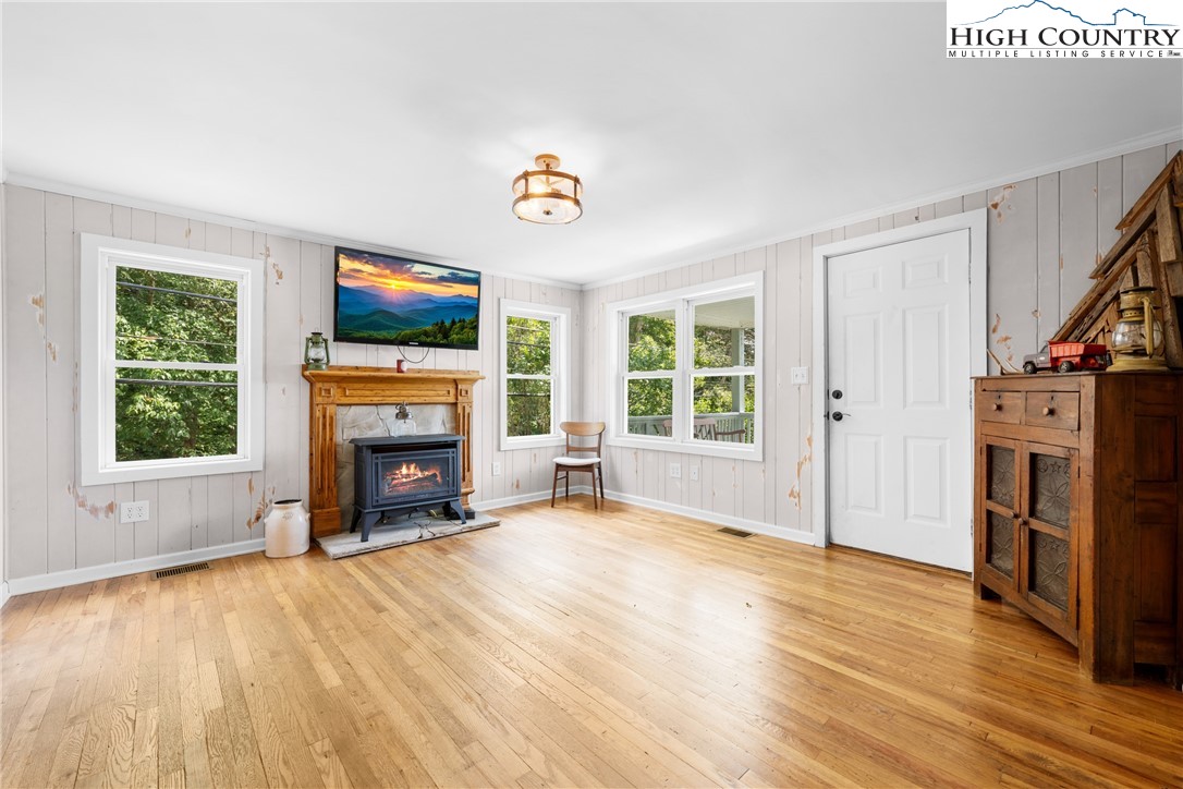 261 Tumbling Brook Road Banner Elk, NC 28604 - Photo 12 of 39 a view of an empty room with a fireplace and a window
