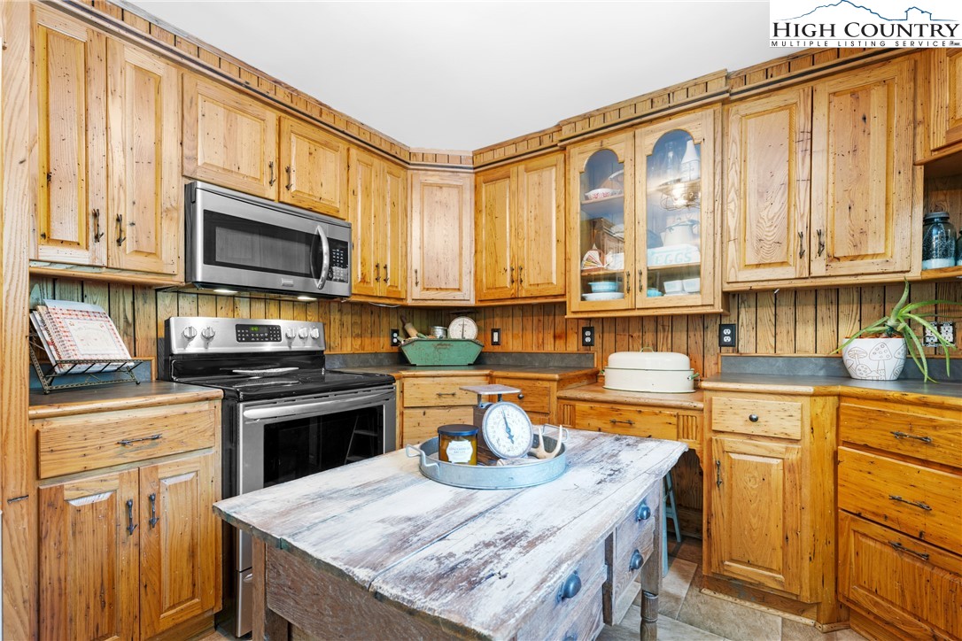 261 Tumbling Brook Road Banner Elk, NC 28604 - Photo 15 of 39 a kitchen with stainless steel appliances granite countertop a stove a sink and a microwave
