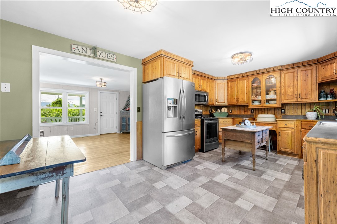 261 Tumbling Brook Road Banner Elk, NC 28604 - Photo 16 of 39 a kitchen with a sink appliances and a counter top space