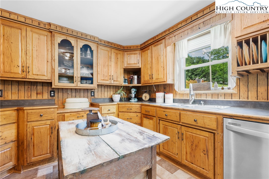 261 Tumbling Brook Road Banner Elk, NC 28604 - Photo 18 of 39 a kitchen with stainless steel appliances granite countertop a stove a sink dishwasher and cabinets with wooden floor