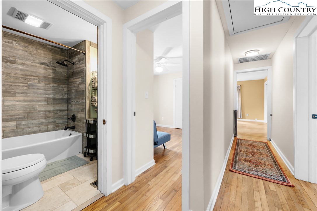 261 Tumbling Brook Road Banner Elk, NC 28604 - Photo 24 of 39 a bathroom with a tub toilet and a shower