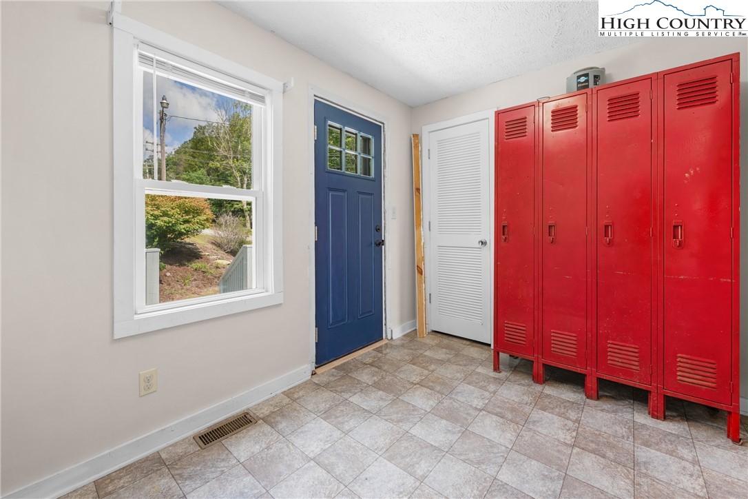 261 Tumbling Brook Road Banner Elk, NC 28604 - Photo 27 of 39 an empty room with window front door