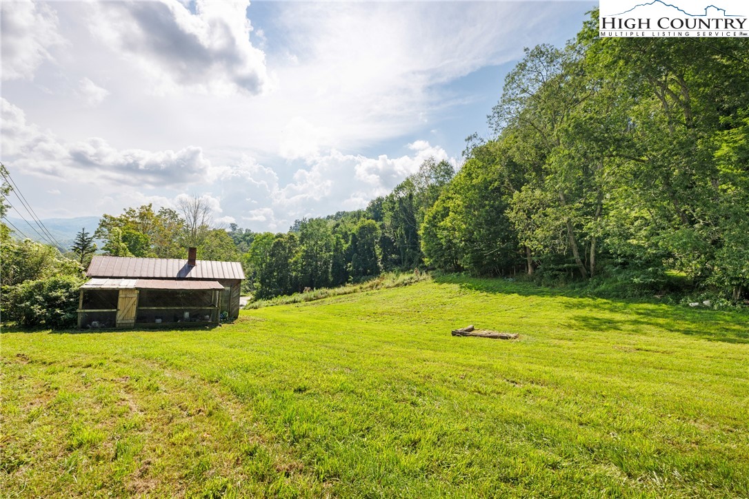261 Tumbling Brook Road Banner Elk, NC 28604 - Photo 35 of 39 a view of a swimming pool with a yard