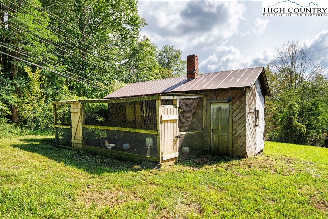 261 Tumbling Brook Road Banner Elk, NC 28604 - Photo 36 of 39 a view of a barn in the middle of a yard