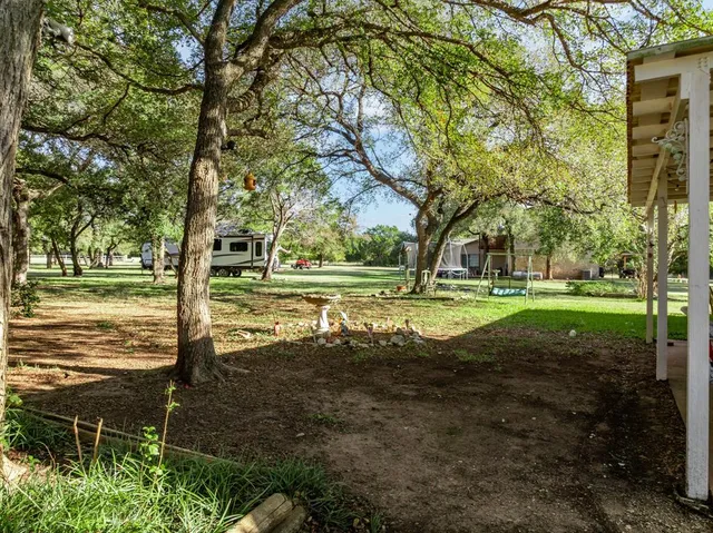 a view of a patio with table and chairs and couches with wooden floor