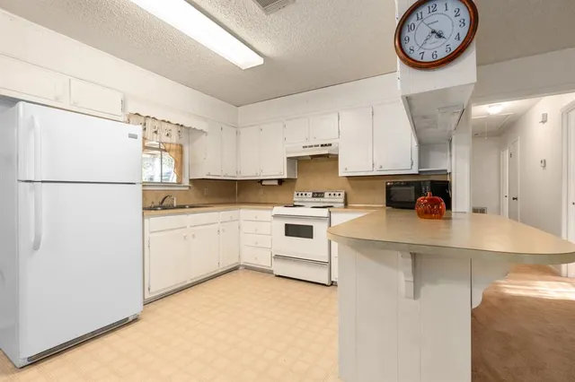 a kitchen with stainless steel appliances a refrigerator sink and cabinets