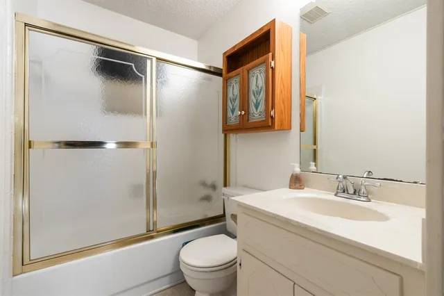 a view of washer and dryer with white cabinets