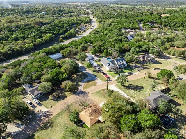 an aerial view of a house with a yard