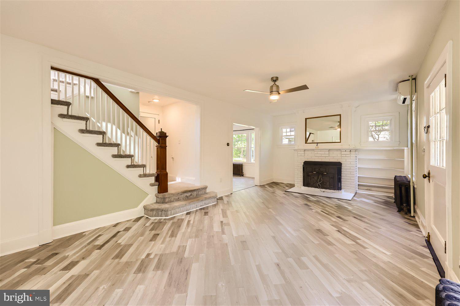 105 East Maple Road Linthicum Heights, MD 21090 - Photo 8 of 37 a view of a livingroom with wooden floor and a fireplace