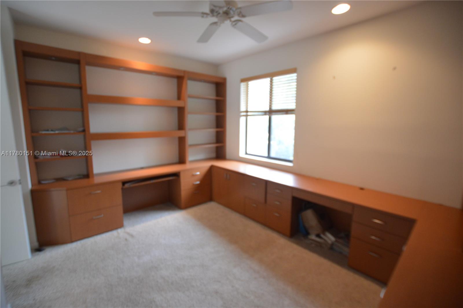 1141 Southwest 20th Avenue Boca Raton, FL 33486 - Photo 8 of 15 walk in closet with window and cabinet