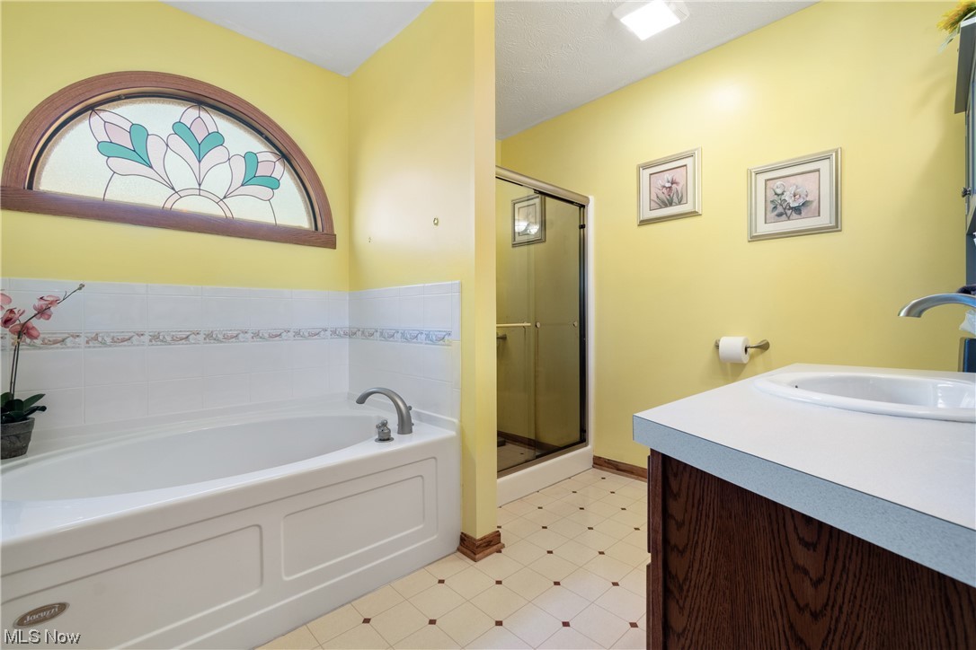 8366 Turquoise Avenue Northeast Canton, OH 44721 - Photo 15 of 26 Master bathroom featuring a soaker tub and separate shower.