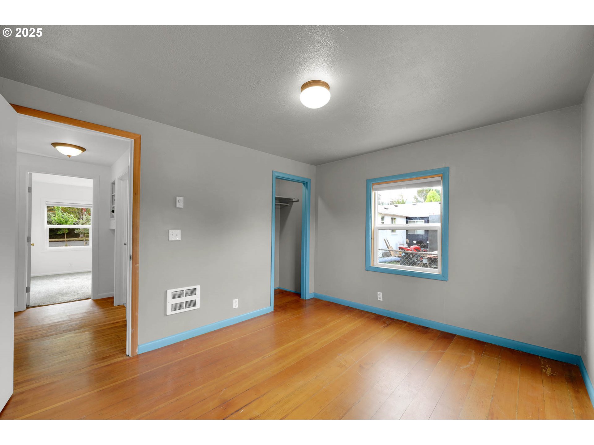 335 East 34th Avenue Eugene, OR 97405 - Photo 17 of 24 a view of an empty room with wooden floor and a window