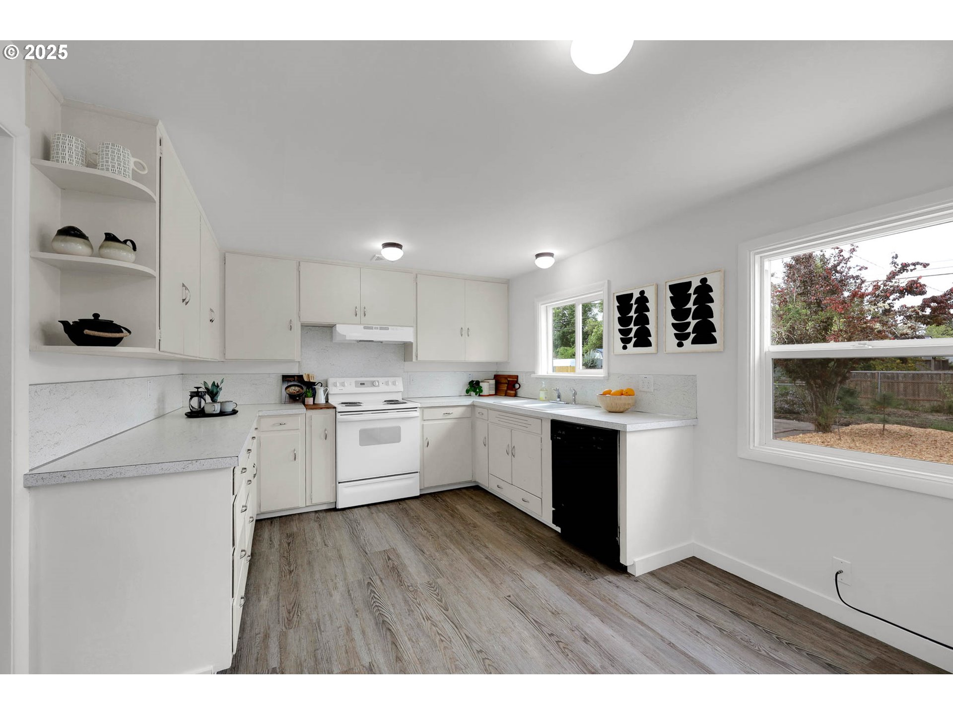 335 East 34th Avenue Eugene, OR 97405 - Photo 6 of 24 a large white kitchen with window and wooden floor