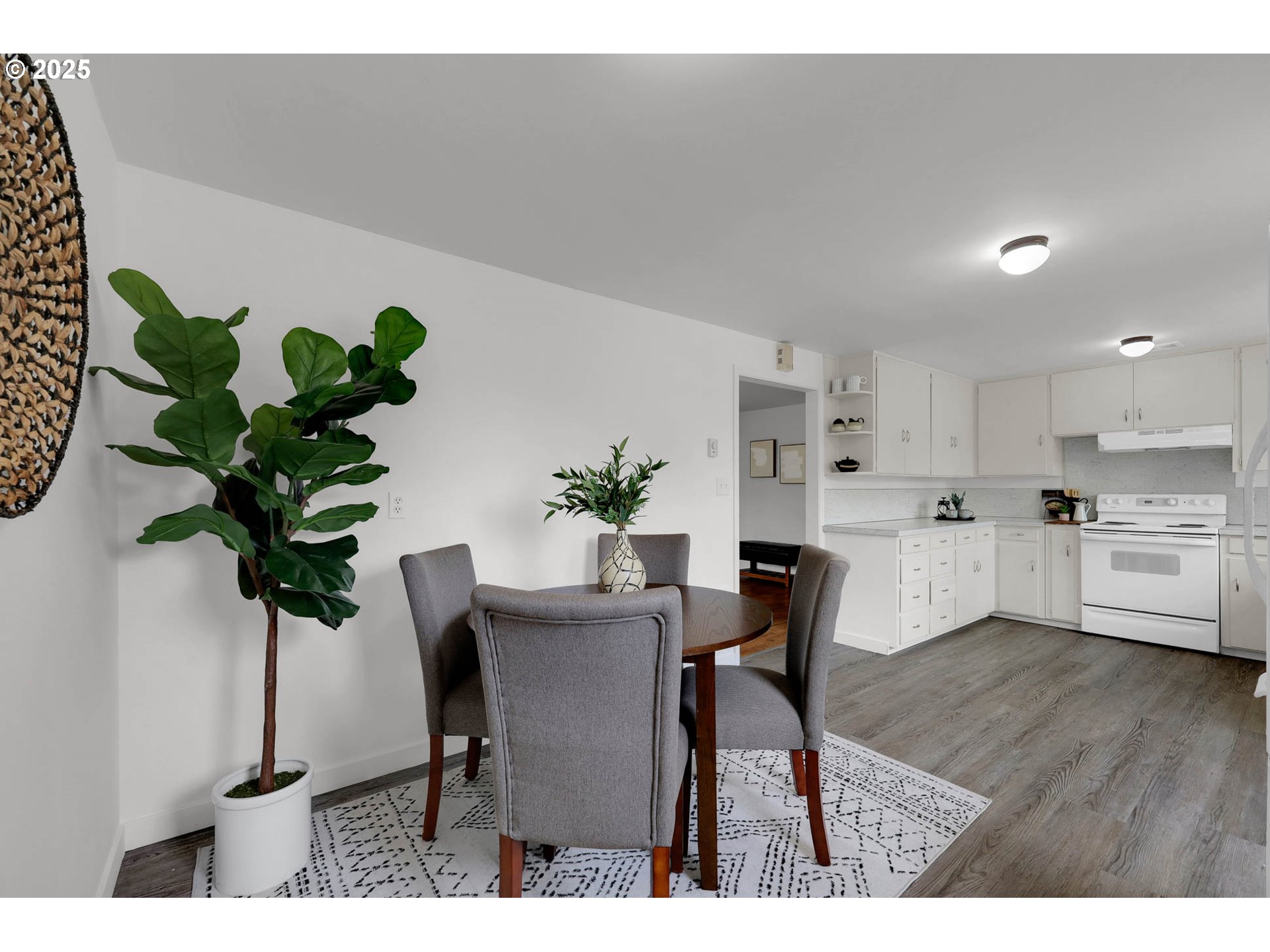335 East 34th Avenue Eugene, OR 97405 - Photo 9 of 24 a view of a dining room with furniture a potted plant and wooden floor