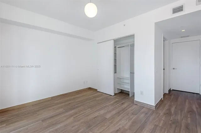 a view of a room with wooden floor