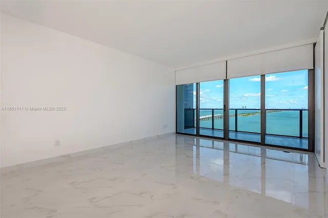 an empty room with sliding glass door