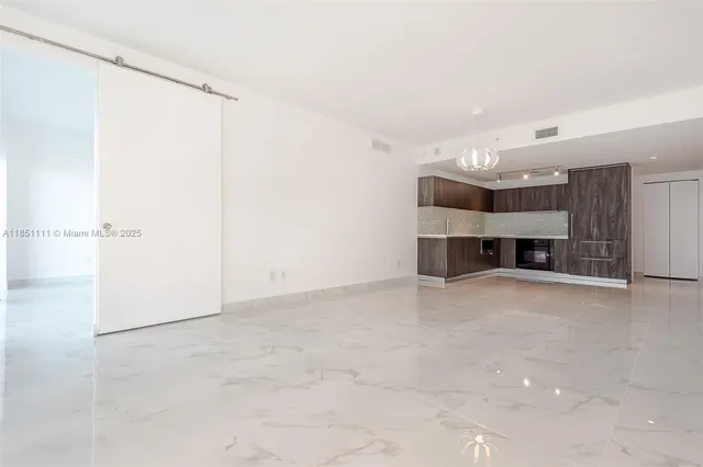 an empty room with a fireplace and cabinet