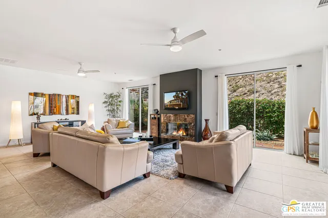 a living room with furniture and a fireplace