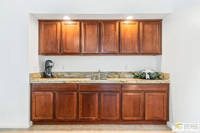 a kitchen with stainless steel appliances granite countertop a sink a stove and a refrigerator