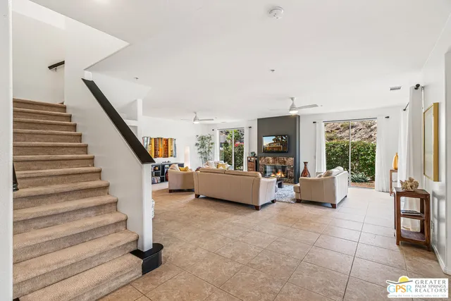 a kitchen with a sink a stove cabinets and wooden floor