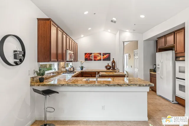 a spacious bedroom with a bed a couch and a view of bathroom