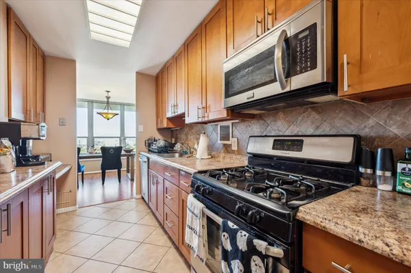 a kitchen with stainless steel appliances granite countertop a stove and a sink