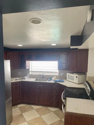 a kitchen with a sink a stove and refrigerator