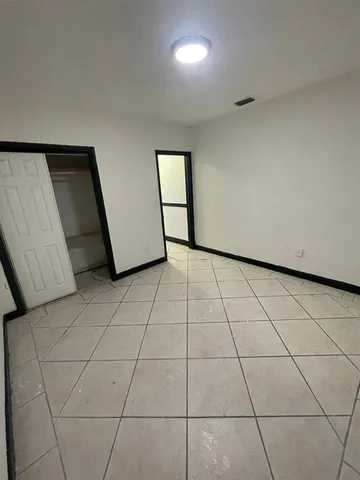 a view of a livingroom with an empty space and a window