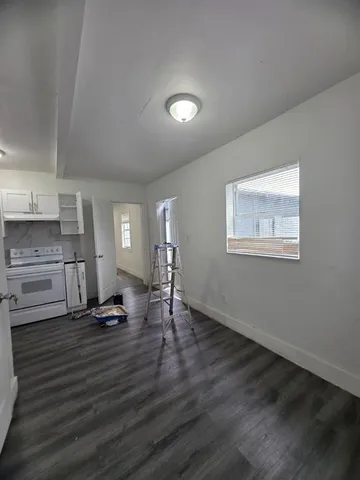 a view of a livingroom with wooden floor and a window