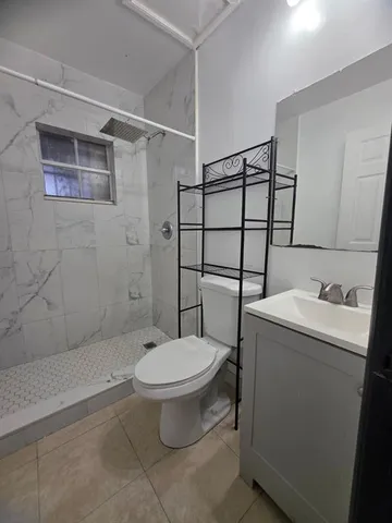 a bathroom with a toilet sink and shower