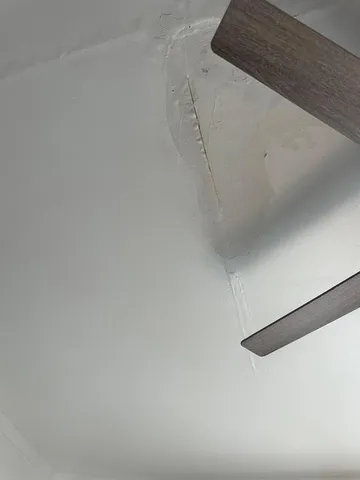 a view of empty room with wooden floor and window