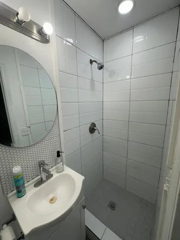 a bathroom with a sink and mirror with toilet