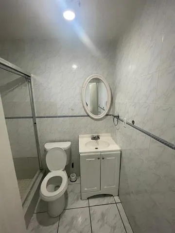 a bathroom with a toilet a sink and a mirror