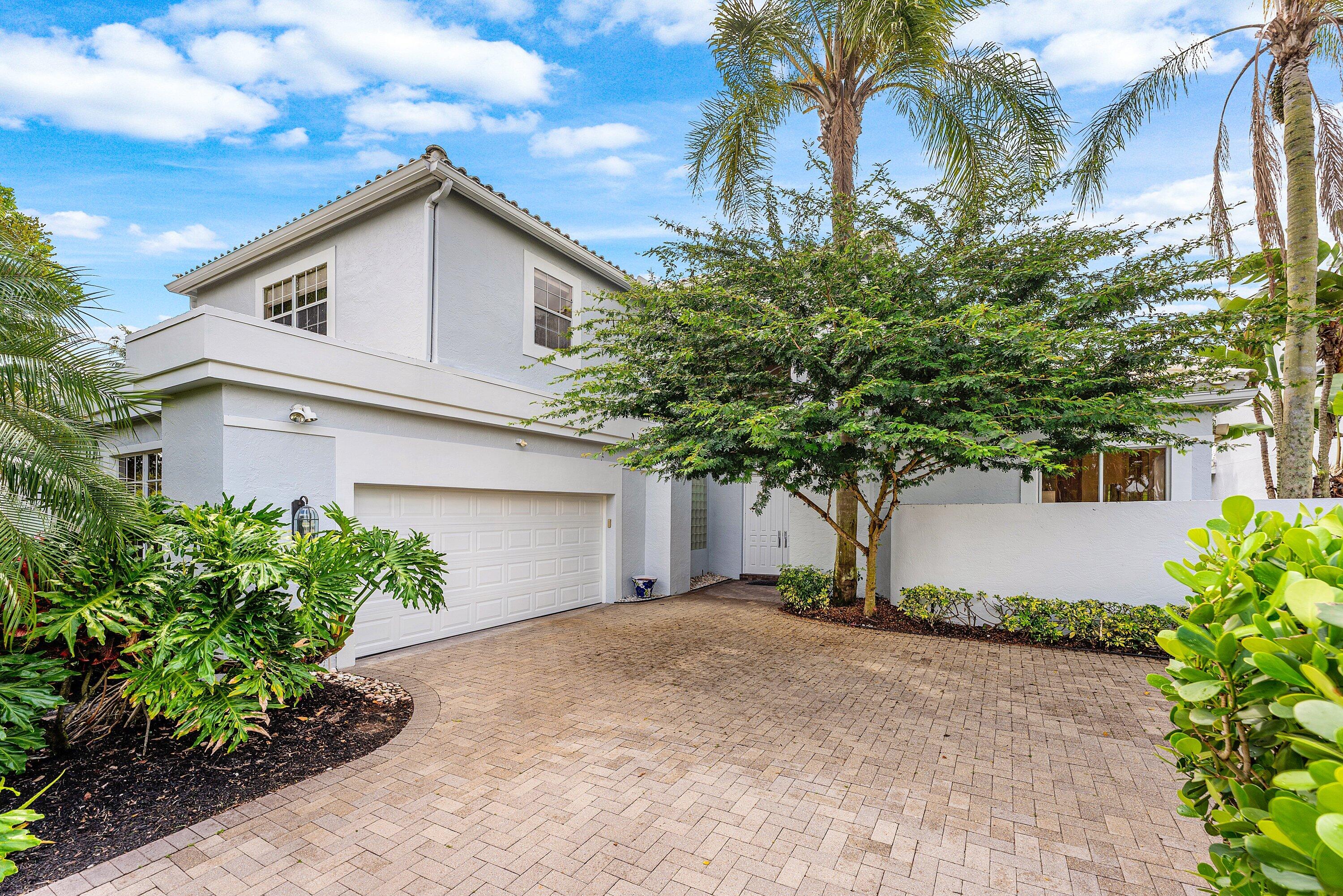 a view of a house with a tree and plants