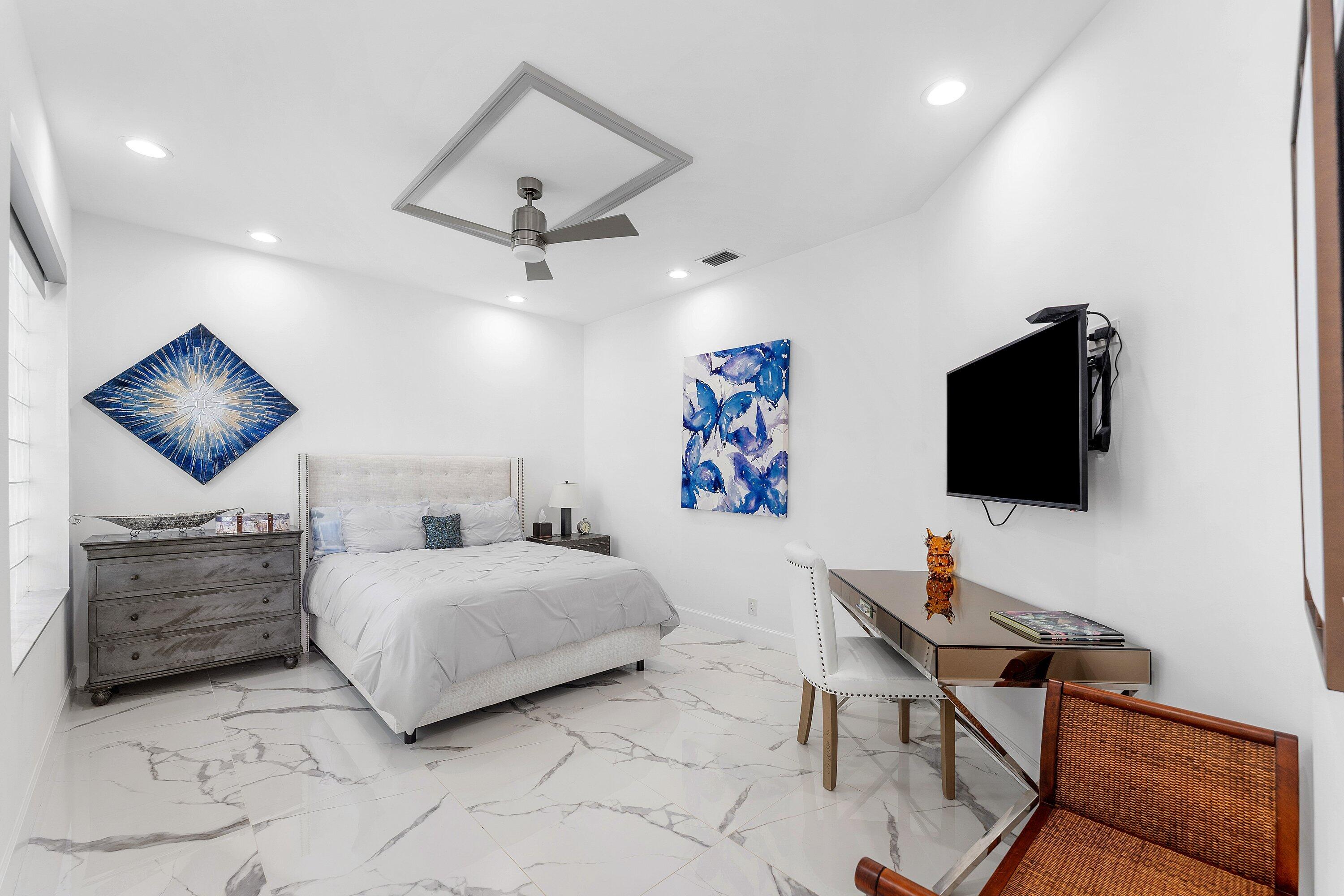 5863 Waterford Boca Raton, FL 33496 - Photo 25 of 90 a bedroom with a bed and a flat screen tv