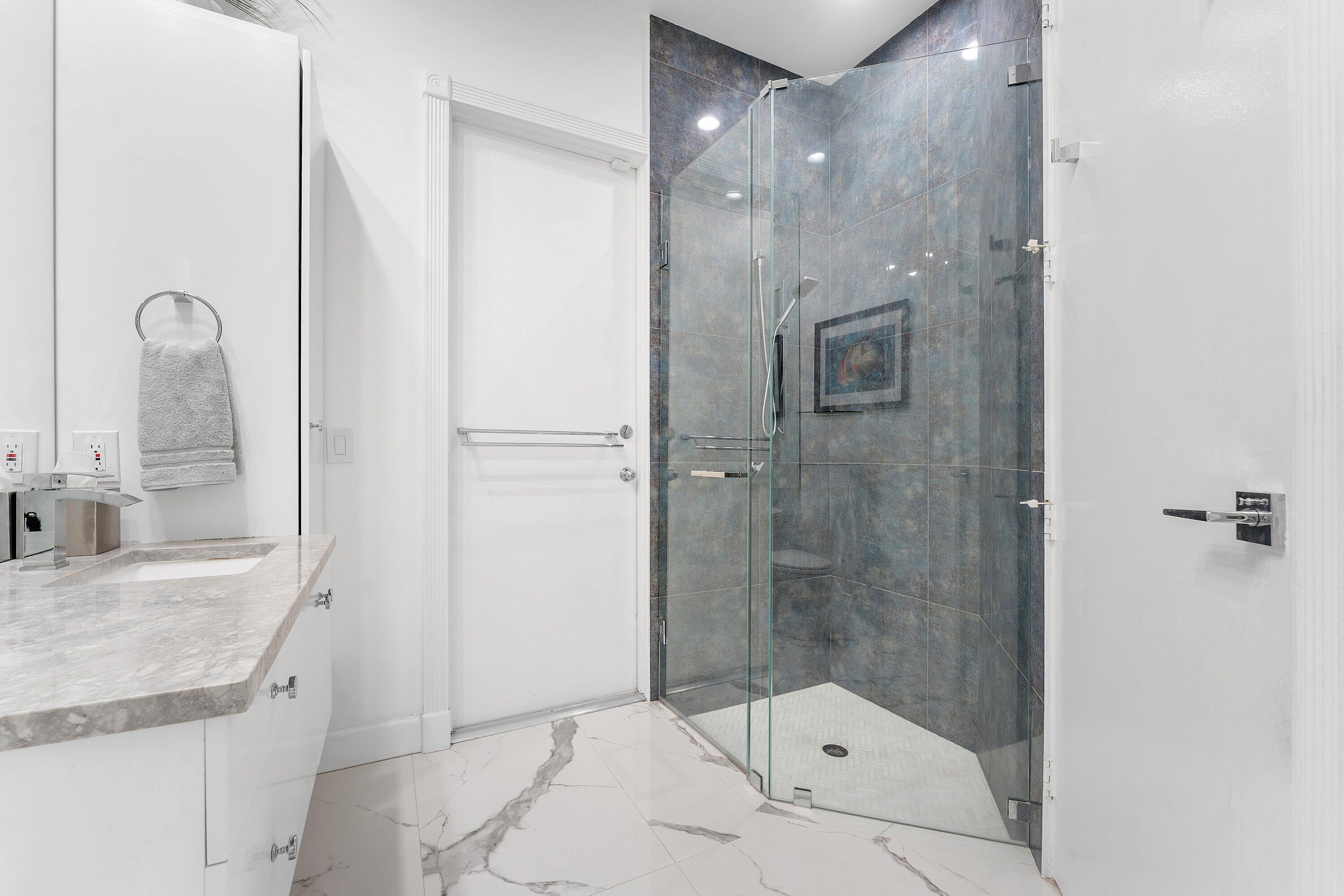 5863 Waterford Boca Raton, FL 33496 - Photo 26 of 90 a bathroom with a granite countertop sink a toilet and shower
