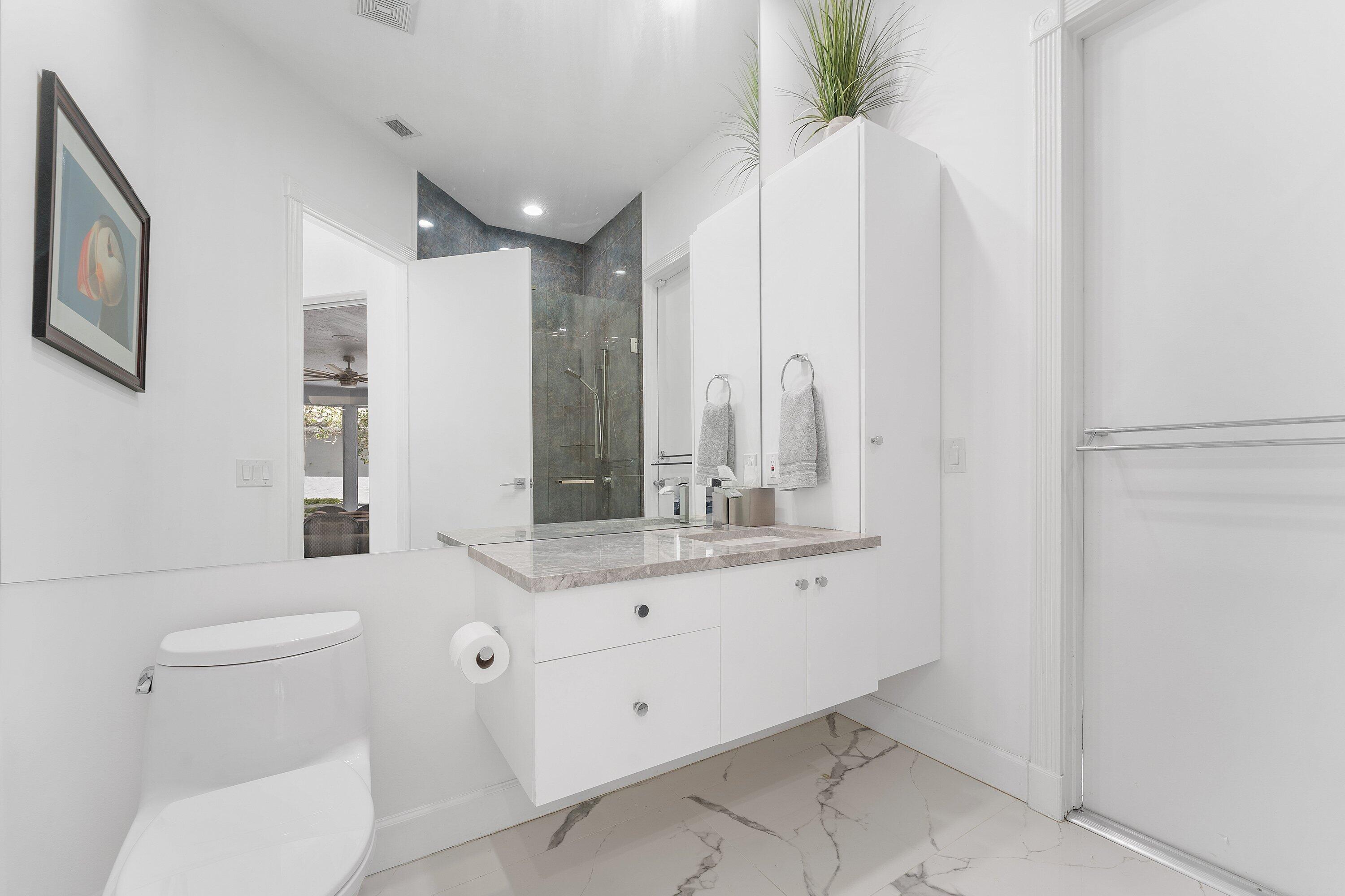 5863 Waterford Boca Raton, FL 33496 - Photo 27 of 90 a bathroom with a sink a toilet and mirror