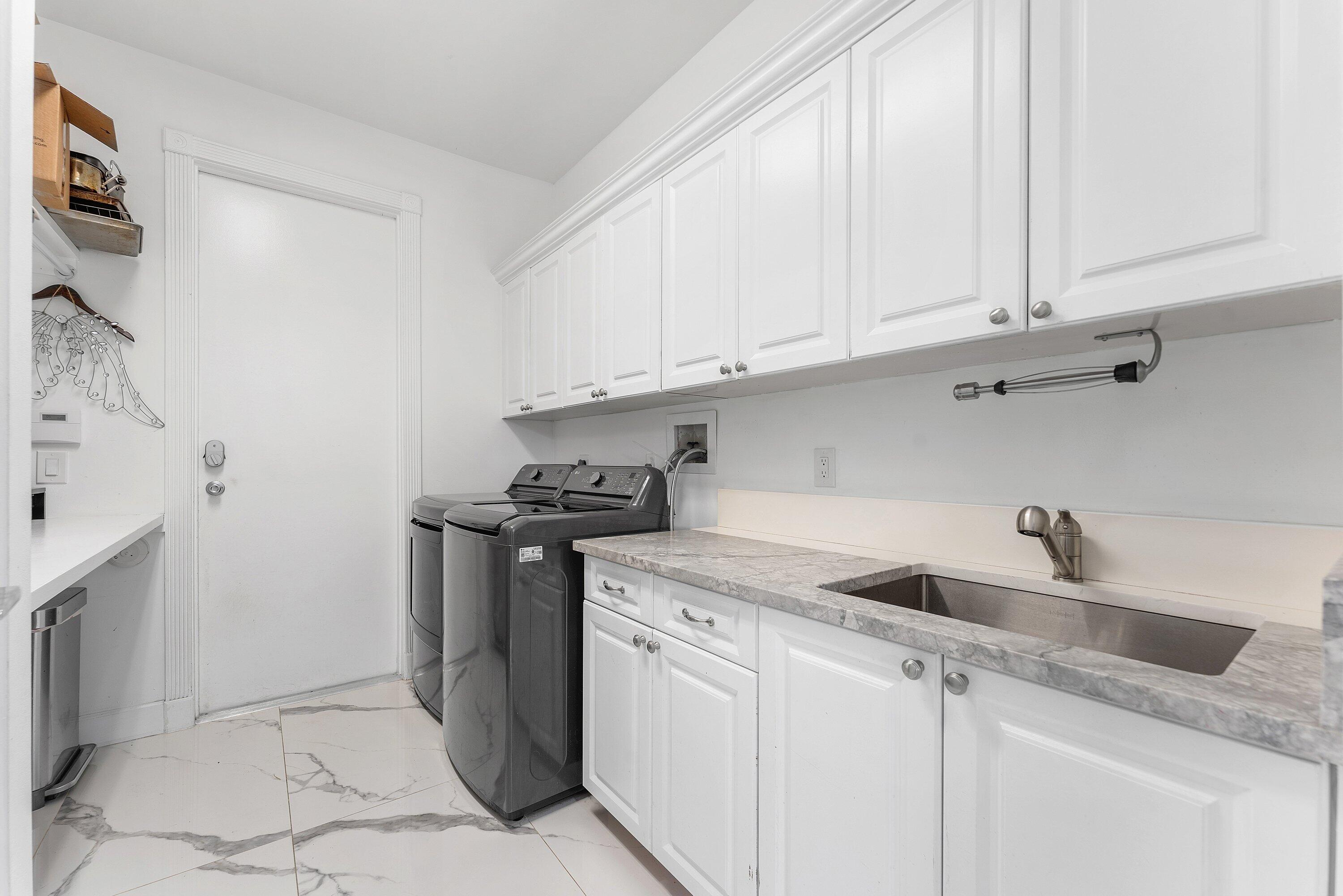 5863 Waterford Boca Raton, FL 33496 - Photo 28 of 90 a kitchen with stainless steel appliances granite countertop a sink and a white cabinets