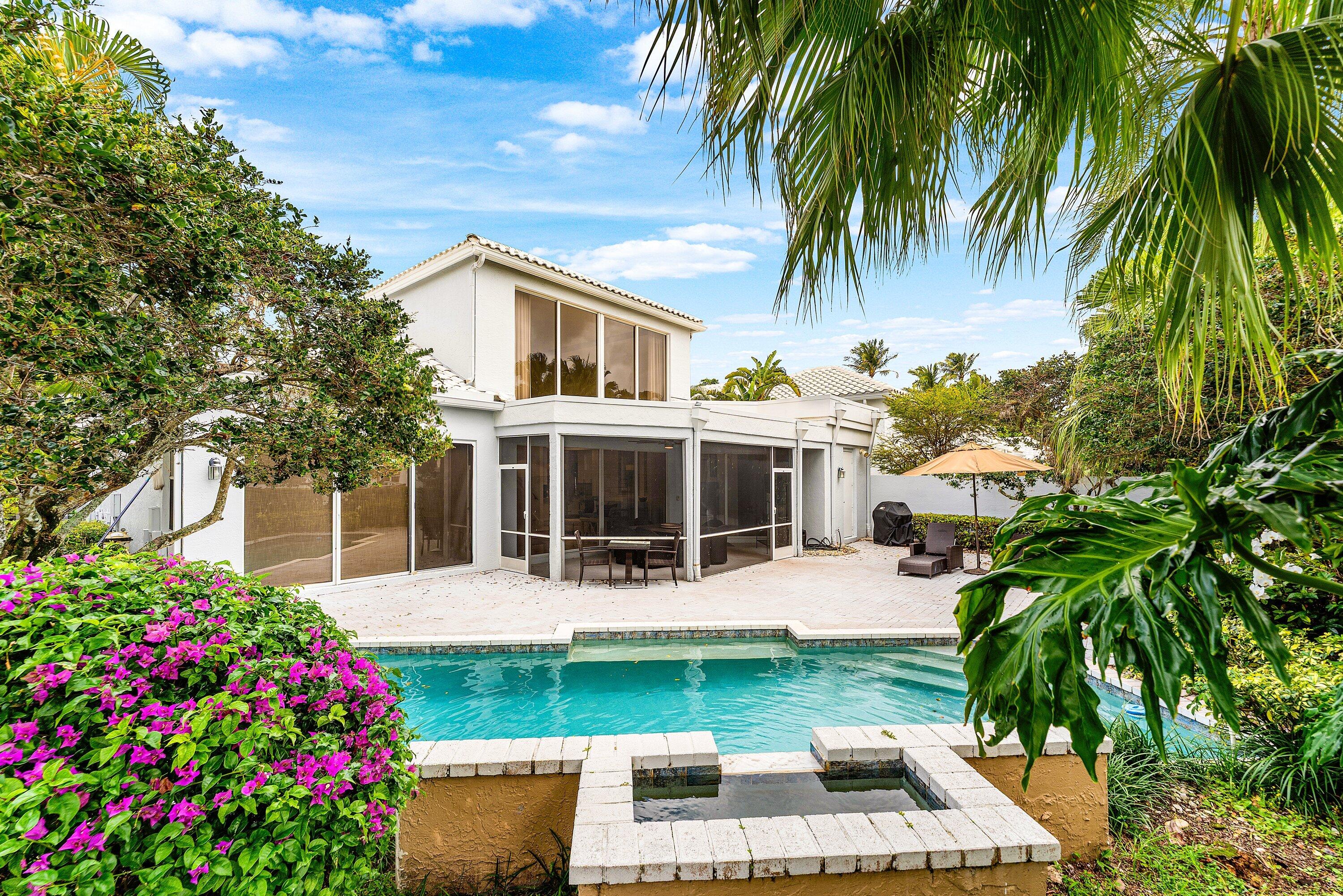 5863 Waterford Boca Raton, FL 33496 - Photo 31 of 90 a front view of house with yard and outdoor seating