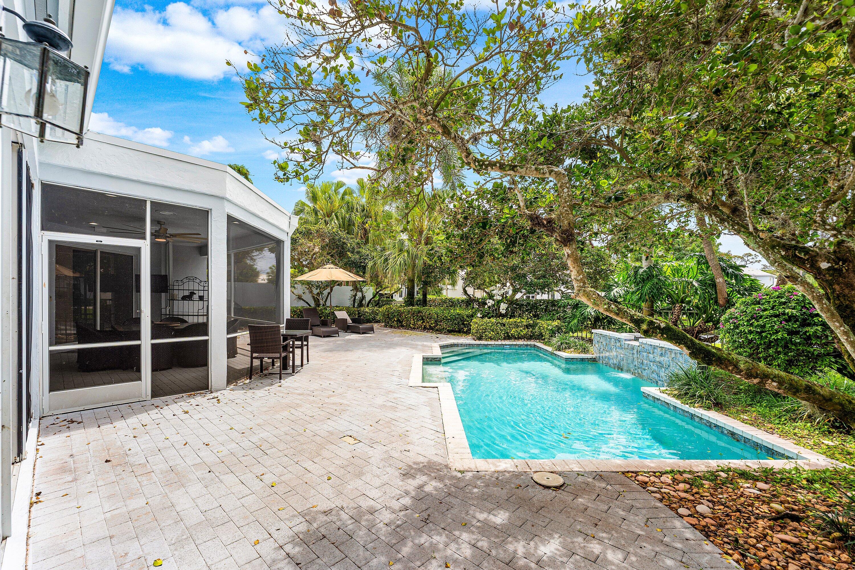 5863 Waterford Boca Raton, FL 33496 - Photo 32 of 90 a view of a backyard with table and chairs and potted plants