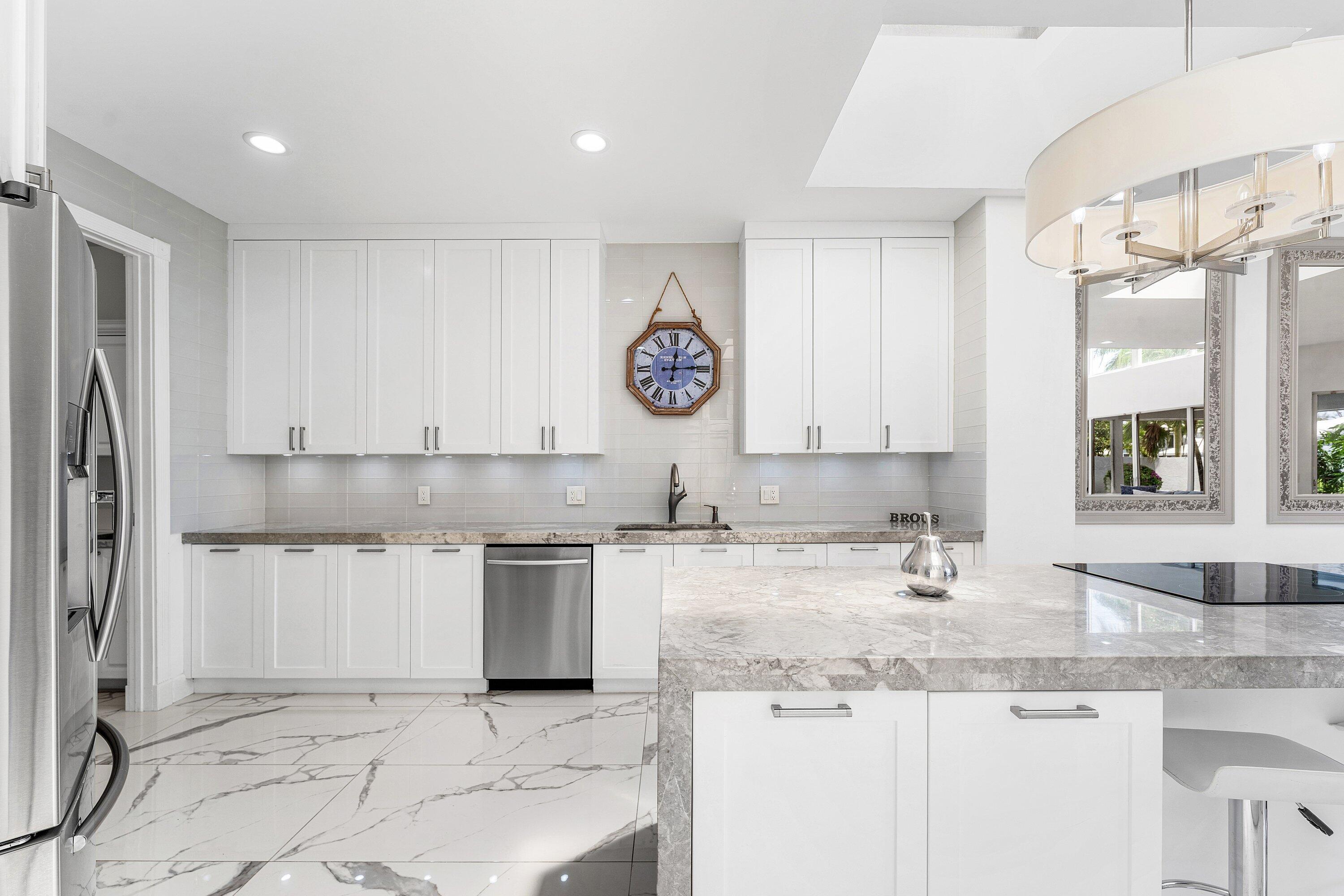 5863 Waterford Boca Raton, FL 33496 - Photo 9 of 90 a kitchen with granite countertop a sink a stove and cabinets