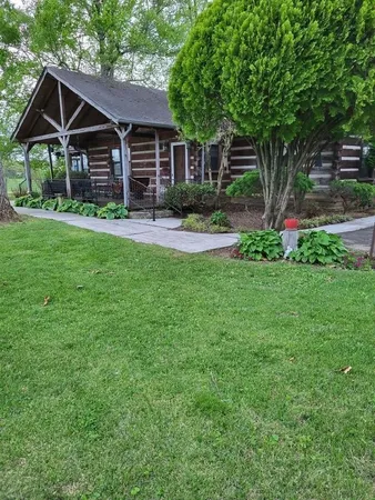 a front view of house with yard and green space
