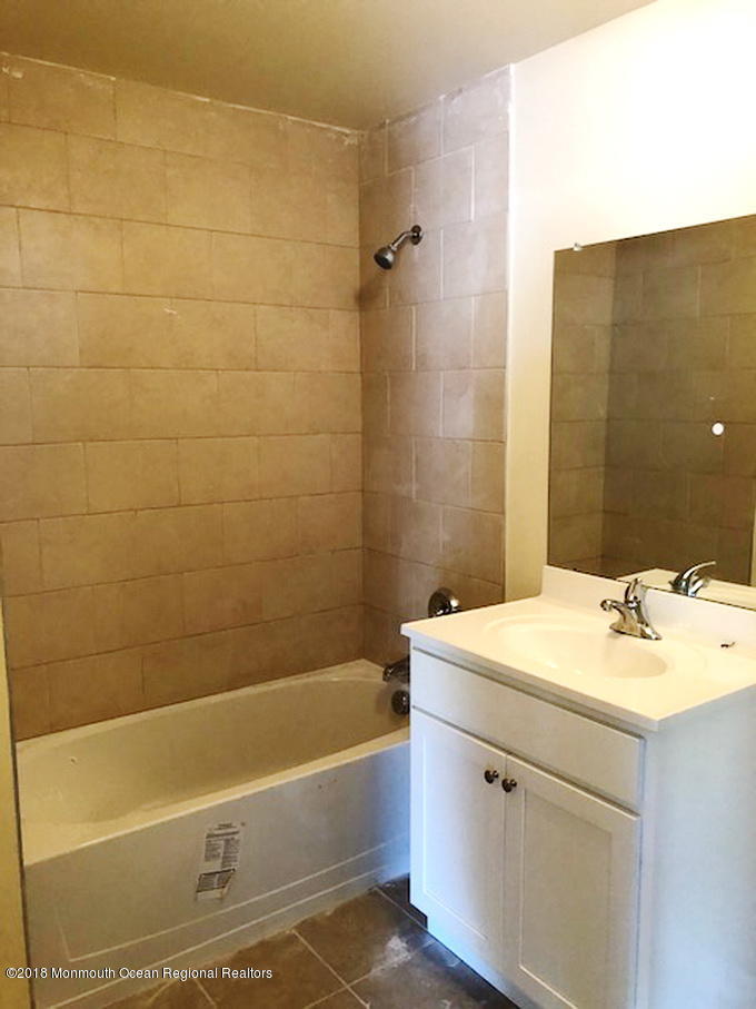 8 Abbey Road Tinton Falls, NJ 07753 - Photo 6 of 6 a bathroom with a sink and a bathtub