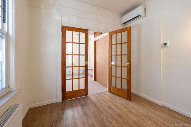 wooden floor in an empty room with a window