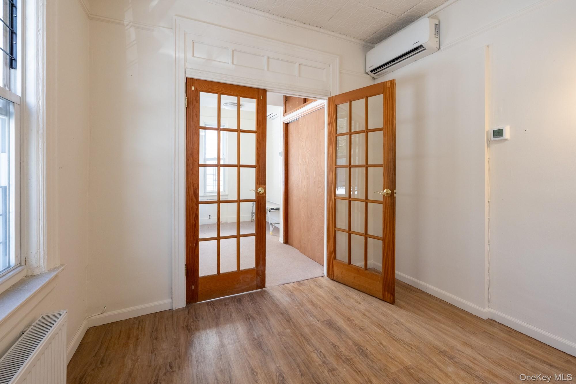 677 Van Nest Avenue Bronx, NY 10462 - Photo 12 of 49 wooden floor in an empty room with a window