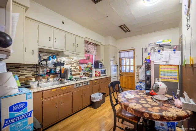 a kitchen that has a table and chairs in it